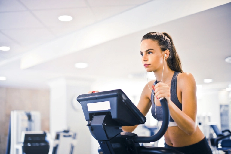 Woman performing fasted cardio on elliptical trainer
