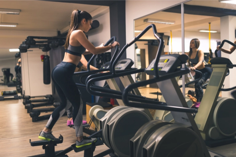woman performing fasted cardio on elliptical machine